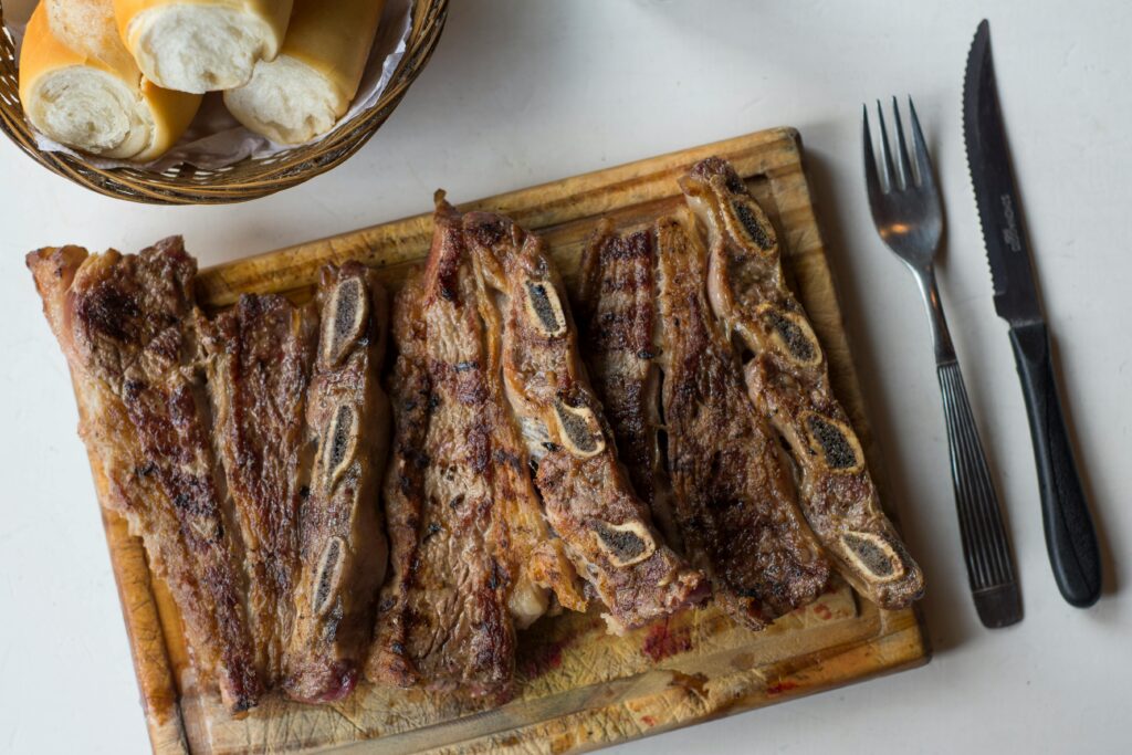 Delicious traditional Argentine asado, grilled steaks with bread, perfect for a classic meal.