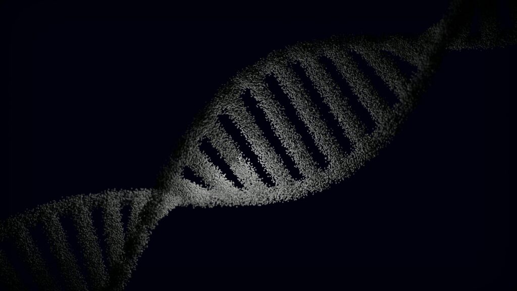 Artistic rendering of a DNA strand with particle effects against a dark background.