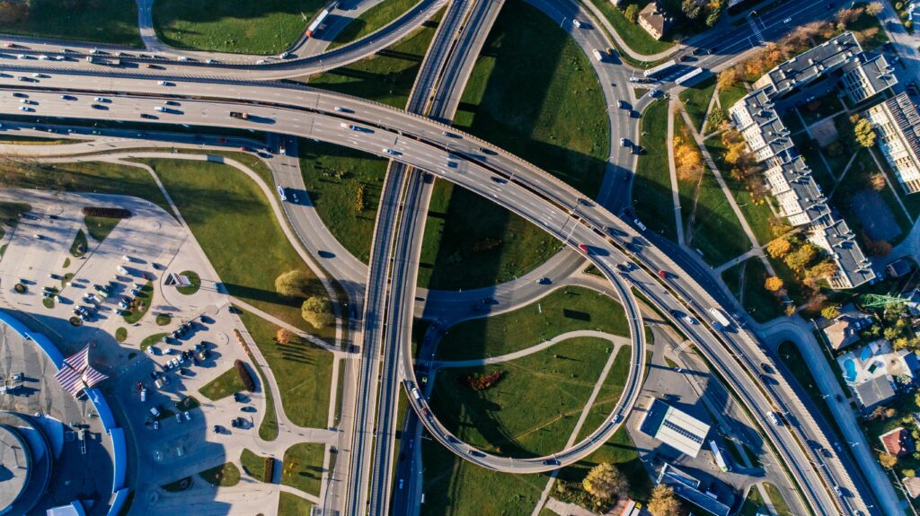 Aerial photograph of a complex highway interchange, capturing dynamic city traffic.