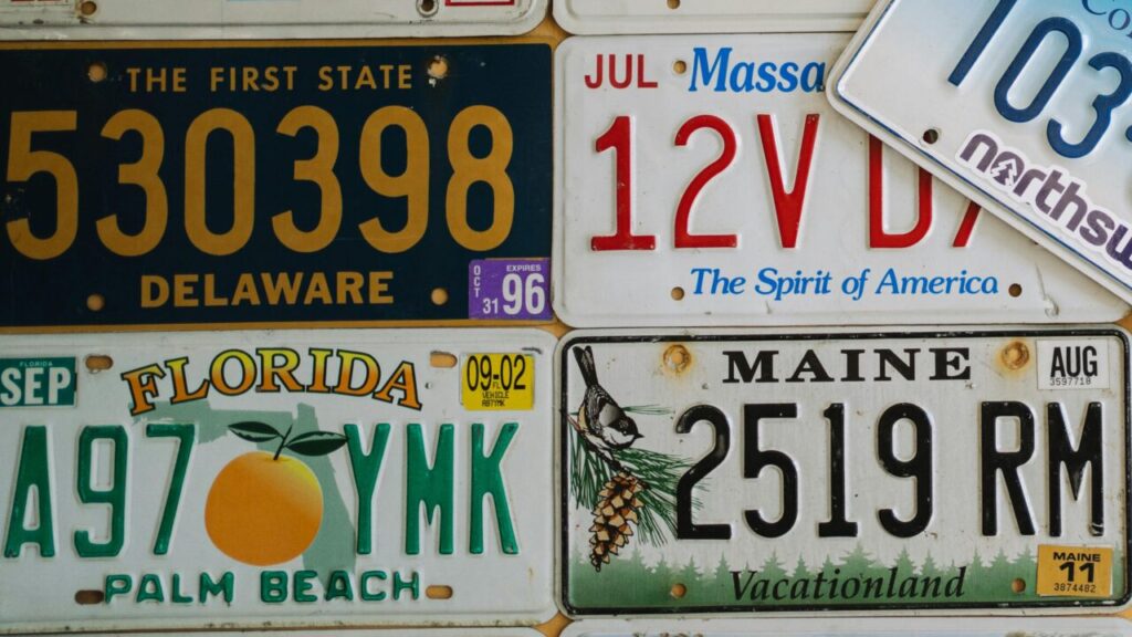 A colorful collage of vintage US license plates from various states on display.