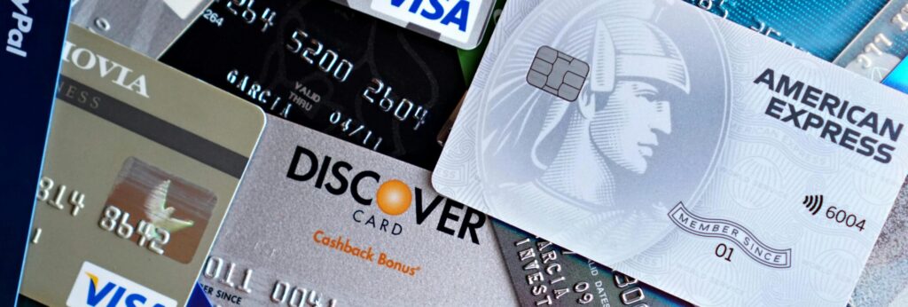 Close-up image of various credit cards including Visa, Mastercard, and American Express.