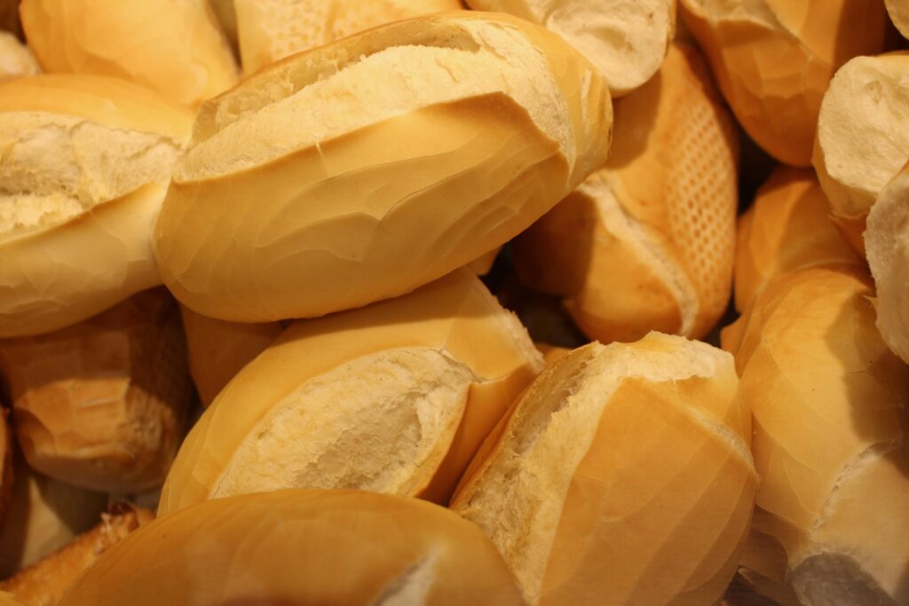 A close-up view showcasing a pile of freshly baked bread rolls with golden crusts.